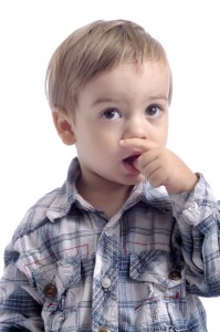 young boy with thumb in mouth